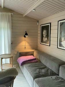 a room with a couch in the corner of a room at Holiday Home Near Tisvilde Forest And Rhubarb Farm in Vejby Strand +10 photos