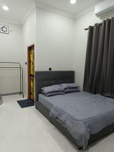 a bedroom with a large bed in a room at ZZD Gunong Roomstay in Bachok +16 photos