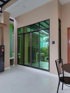 an empty room with glass doors in a building at ZZD Gunong Roomstay in Bachok