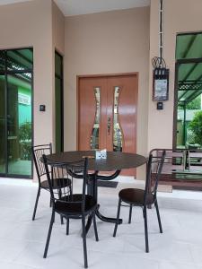 a black table and chairs in a building at ZZD Gunong Roomstay in Bachok