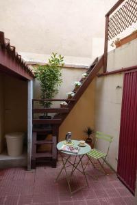 a table and a chair on a patio with a staircase at Casa Rural del Sol in Zamarramala