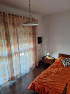 a bedroom with a bed and a large window at Espectacular Departamento in Rosario +7 photos