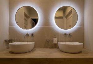 two sinks in a bathroom with two mirrors at yah homes takasago in Fukuoka +49 photos