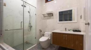 a bathroom with a shower and a toilet and a sink at Hoang Hung Hotel in Hanoi +82 photos