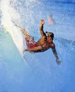 a man riding a wave on a surfboard in the water at Retro Star-Wagon, Ocean View Dolby Sound Studio in Oceanside