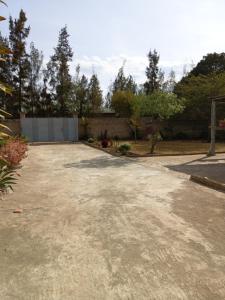 an empty driveway in a yard with a fence at Serene Haven of Rest in Iringa