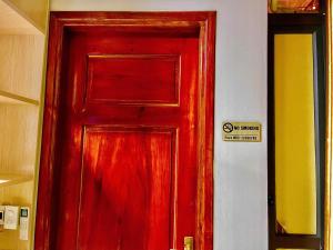 a red door in a room with a sign on it at Home 33 in Sapa +58 photos