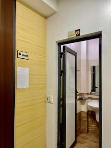 a bathroom with a door with a sink and a toilet at Home 33 in Sapa