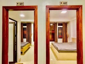 a bedroom with two mirrors and a bed in a room at Home 33 in Sapa