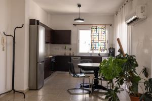 a kitchen with a table and a refrigerator at Penthouse, City Center, Walking to Beach in Larnaka