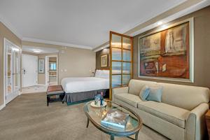 a hotel room with a bed and a couch and a table at Sakura Serenity-View-No Resort Fee in Las Vegas