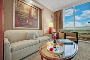 a living room with a couch and a table with wine glasses at Sakura Serenity-View-No Resort Fee in Las Vegas +26 photos