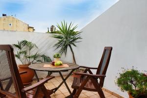 a table with a bowl of fruit on a balcony at Moraitis Mansion in Corfu