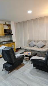 a living room with two chairs and a couch at Apartamento centro Marinilla in Marinilla