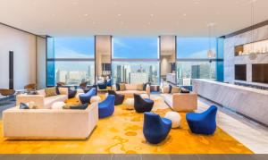 a living room with a view of the city at The Prince Gallery Tokyo Kioicho, a Luxury Collection Hotel in Tokyo