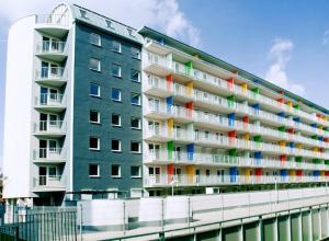 a large apartment building with colorful windows and balconies at Apartament Mozaika in Wrocław