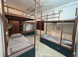 a room with two bunk beds in it at Mosaic Hostel Varanasi in Varanasi