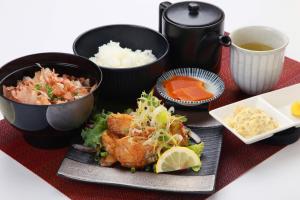 a plate of food with some rice and other foods at Hotel Sunflex Kagoshima in Kagoshima
