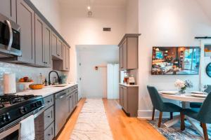 a kitchen with a table and a stove top oven at 2BR Unit near Brown & RISD with Free Parking, Full Kitchen in Providence