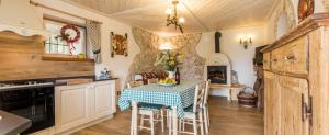 a kitchen with a table and chairs in a room at Baita del Beniamino in Roncegno