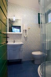 a bathroom with a sink and a toilet at Villa Sol in Vinišće