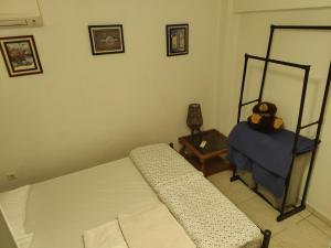 a bedroom with two beds and a teddy bear on a table at Art apartment Syngrou in Athens