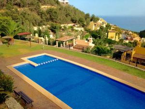 a large blue swimming pool in front of a house at Balcon de Altea hills in Altea