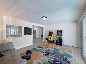 a living room with a couch and two video games at 2631 Cedarglen Drive in Dunedin