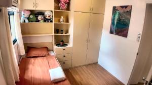 a small bedroom with a bed and some cabinets at Rosalia's in Matina in Davao City