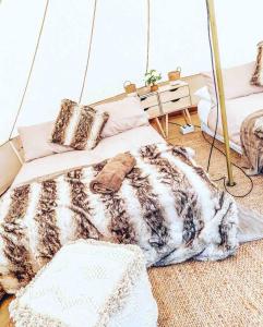 a bed with a blanket and pillows in a room at Aura Glamping Bell Tent in Eumundi +3 photos