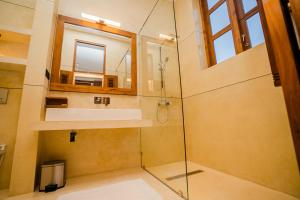 a bathroom with a shower with a sink and a mirror at Madiha Venus in Matara +104 photos