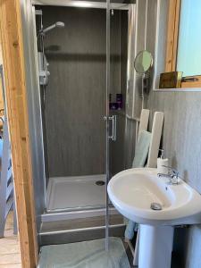 a bathroom with a shower and a sink at The Cabin at Tedburrow rural retreat perfect for couples in Culmstock +85 photos
