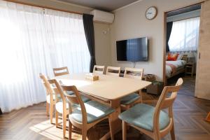 a dining room with a table and chairs and a bedroom at Yasuragi-KAWAGOE 1F in Kawagoe +70 photos