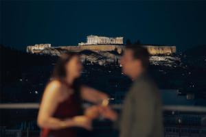 a man and a woman standing in front of the acropolis at Grand Hyatt Athens in Athens +117 photos