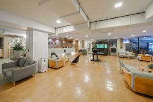 a large lobby with couches and chairs and tables at Icon Park Hotel, Chiang Mai in Chiang Mai