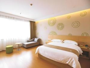 a bedroom with a large bed and a large window at GreenTree Inn Xi'an Terracotta Warriors Huaqing Pool Metro Station in Xi'an