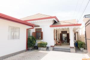 a white house with a red roof at Villa Sea Wave in Hikkaduwa