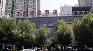 a building with a sign on the top of it at 7 Days Inn Xi'an North Economic Development Zone 4th Fengcheng Road in Xi'an