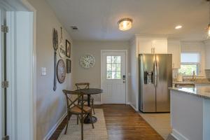 a kitchen with a table and a stainless steel refrigerator at 941 Pine Manor in Mountain Ridge +10 photos