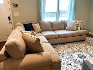 a brown couch in a living room with a window at 941 Pine Manor in Mountain Ridge +9 photos