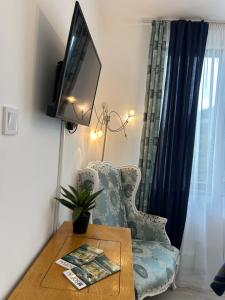 a living room with a chair and a tv at Bulgarane House in Govedartsi +38 photos