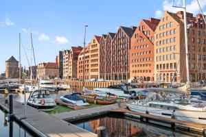 a group of boats docked in a harbor with buildings at GRANO APARTMENTS Gdańsk Granaria in Gdańsk
