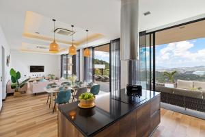 a kitchen and living room with a dining room at Villa Sea Esta Luxury Residence at Chaweng Noi in Koh Samui 