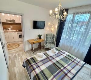 a bedroom with a bed and a table and a chair at Bulgarane House in Govedartsi