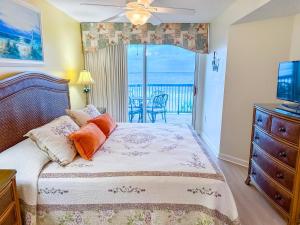 a bedroom with a bed and a balcony at Ashworth 303 in North Myrtle Beach +25 photos