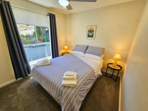 a bedroom with a bed with towels on it at Summer Villa in Kiama