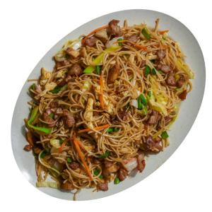 a plate of food with noodles and vegetables at White House Holiday Resort in Matale