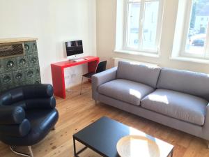 a living room with a couch and a table at Villa Friedrich in Bayreuth