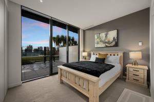 a bedroom with a bed and a large window at Opulent Harbourside Sanctuary in Melbourne +30 photos