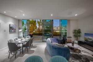 a living room with a blue couch and a table at Opulent Harbourside Sanctuary in Melbourne